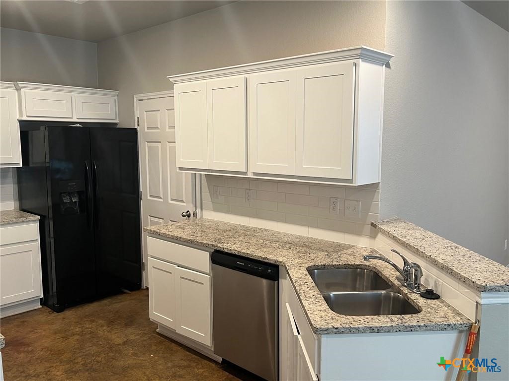 117 East Valley Road Harker Heights, TX 76548 - Photo 4 of 33 a kitchen with granite countertop white cabinets and refrigerator