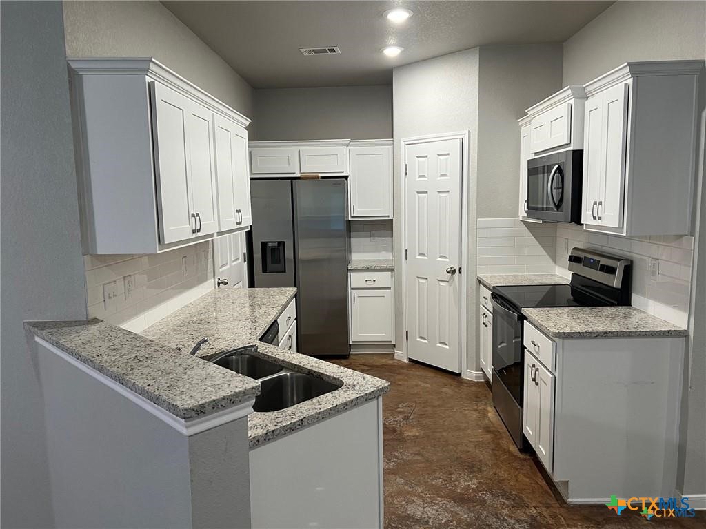 117 East Valley Road Harker Heights, TX 76548 - Photo 5 of 33 a kitchen with stainless steel appliances granite countertop a refrigerator a stove and a sink
