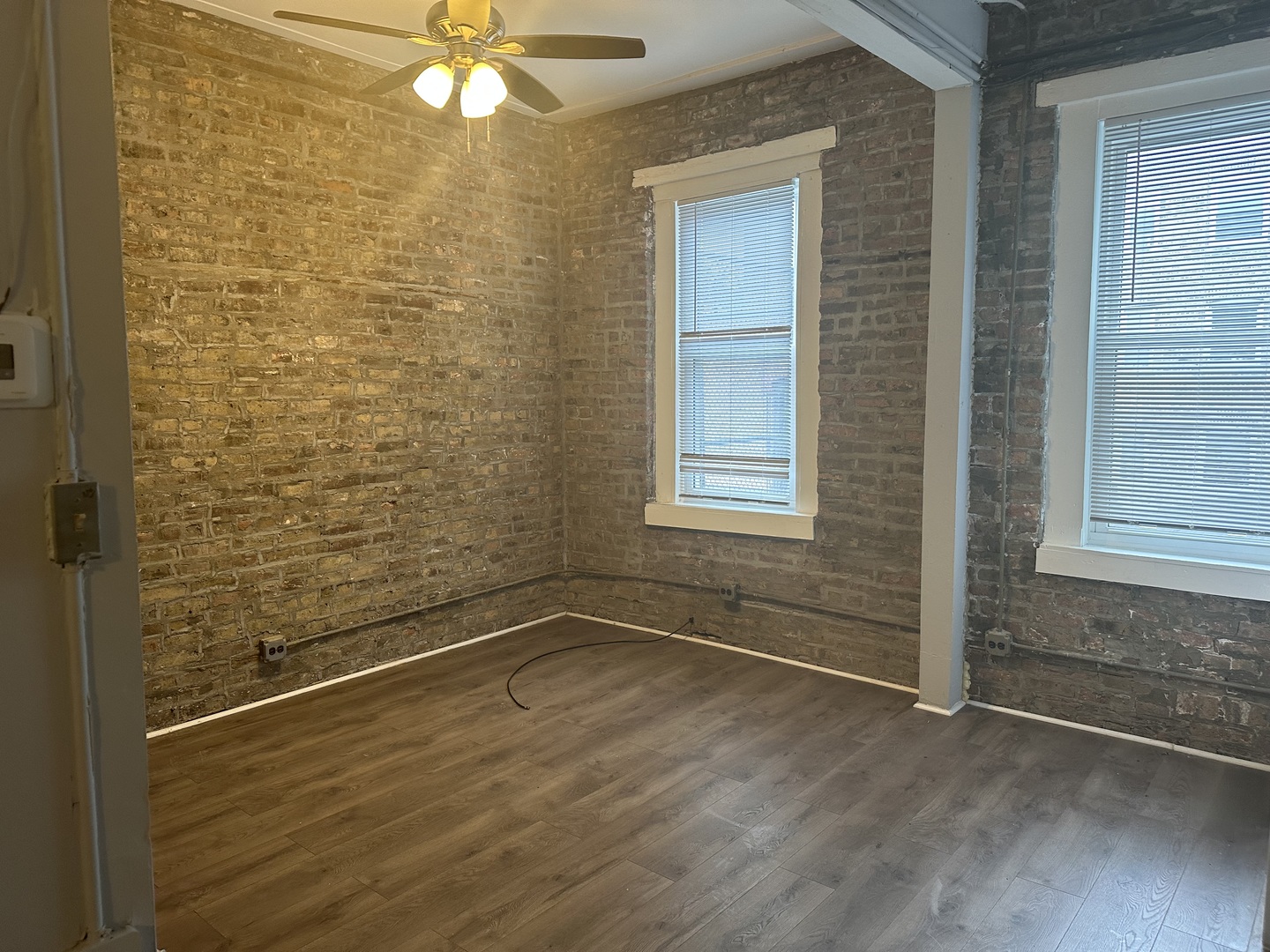 Undisclosed Address Chicago, IL 60622 - Photo 2 of 5 a view of a small space with wooden floor and a window