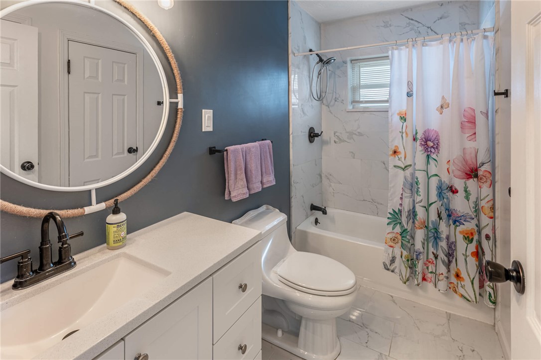 436 Marjorie Avenue Riverside, OH 45404 - Photo 14 of 34 This bathroom features a contemporary vanity with a sleek countertop and a clean, inviting tub-shower combination.