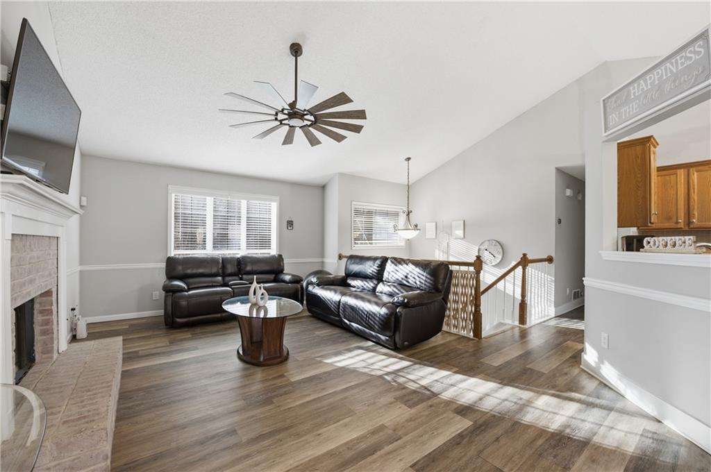 20 Miners Point Acworth, GA 30102 - Photo 4 of 21 a living room with furniture a fireplace and a flat screen tv