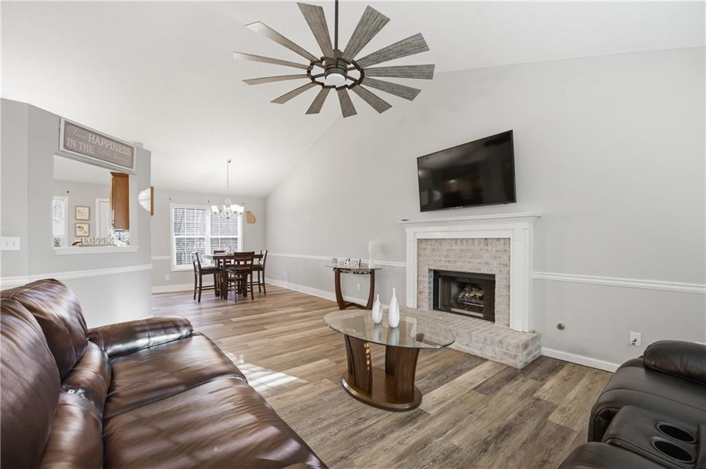 20 Miners Point Acworth, GA 30102 - Photo 5 of 21 a living room with furniture a fireplace and a flat screen tv