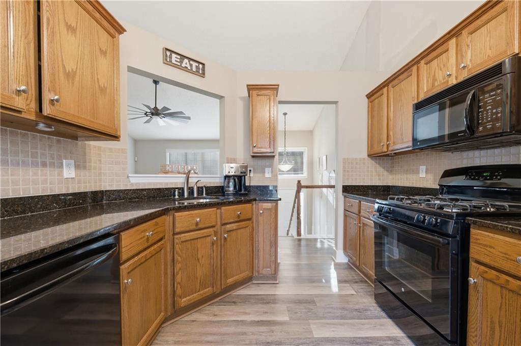 20 Miners Point Acworth, GA 30102 - Photo 6 of 21 a kitchen with stainless steel appliances granite countertop a stove a sink and a microwave