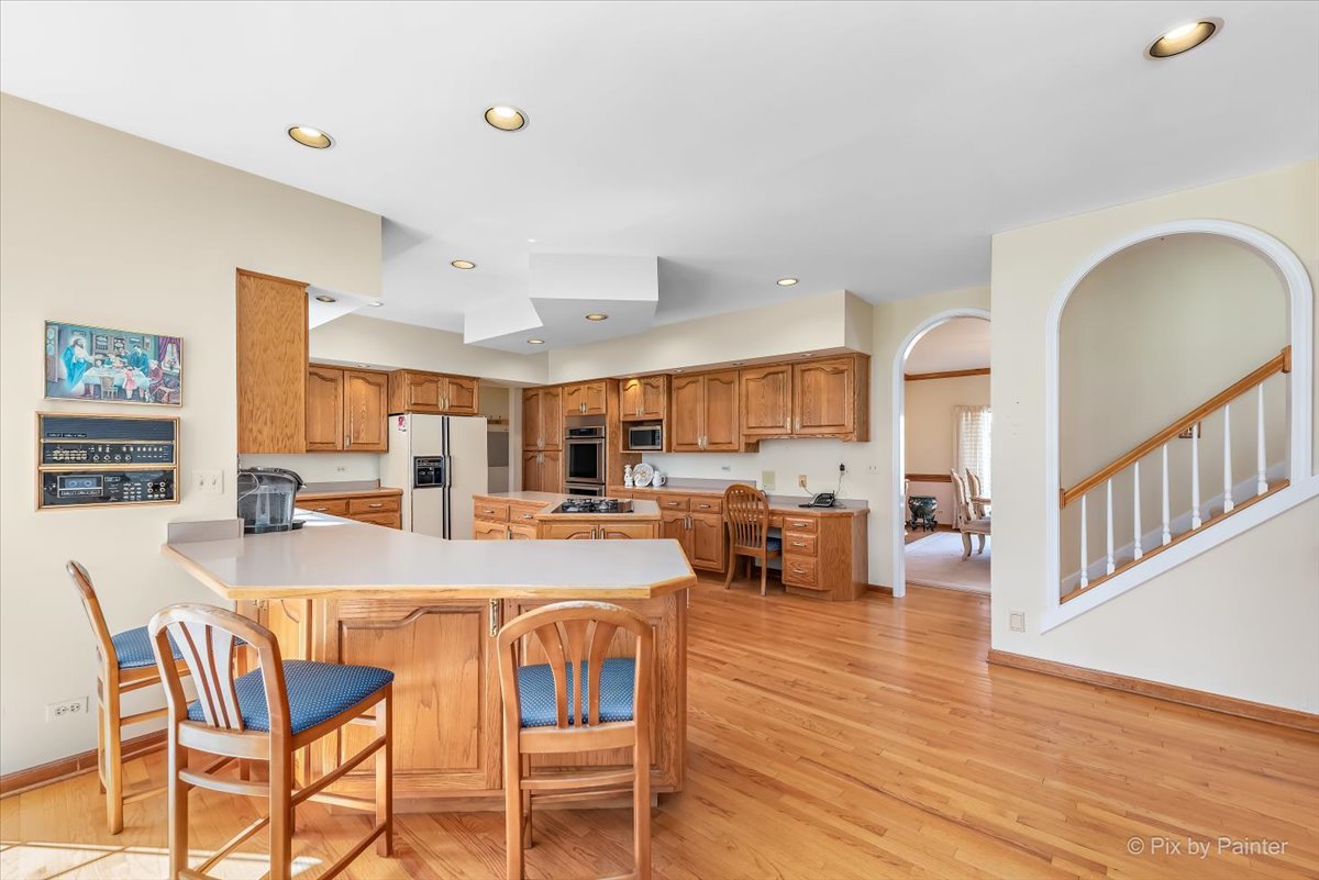 26W461 Churchill Road Winfield, IL 60190 - Photo 12 of 60 a large kitchen with a table and chairs