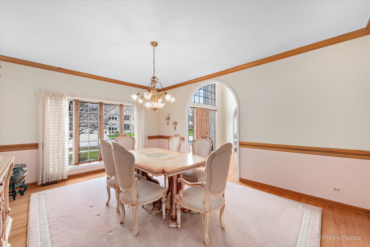 26W461 Churchill Road Winfield, IL 60190 - Photo 16 of 60 a view of a dining room with furniture window and wooden floor