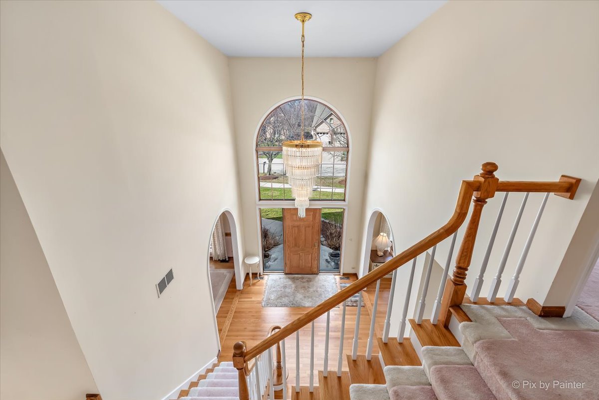 26W461 Churchill Road Winfield, IL 60190 - Photo 17 of 60 a view of a hallway with wooden floor windows
