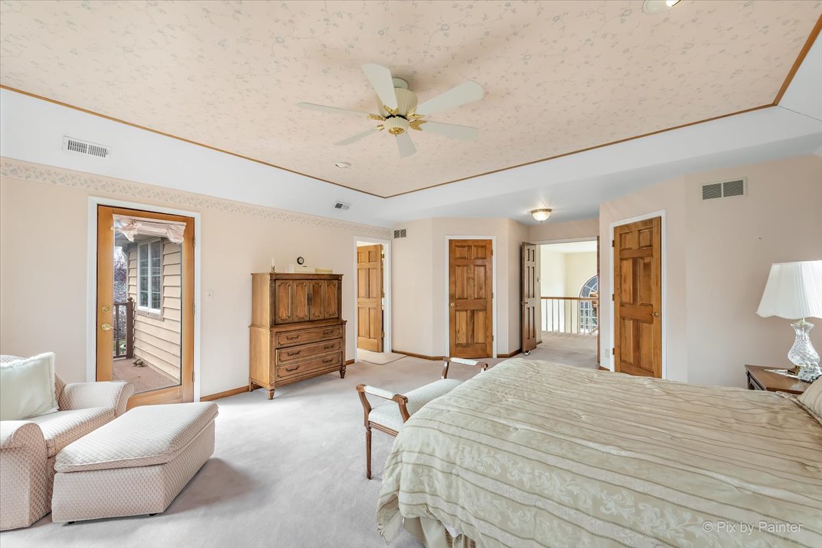 26W461 Churchill Road Winfield, IL 60190 - Photo 21 of 60 a bedroom with a large bed a chandelier and dresser
