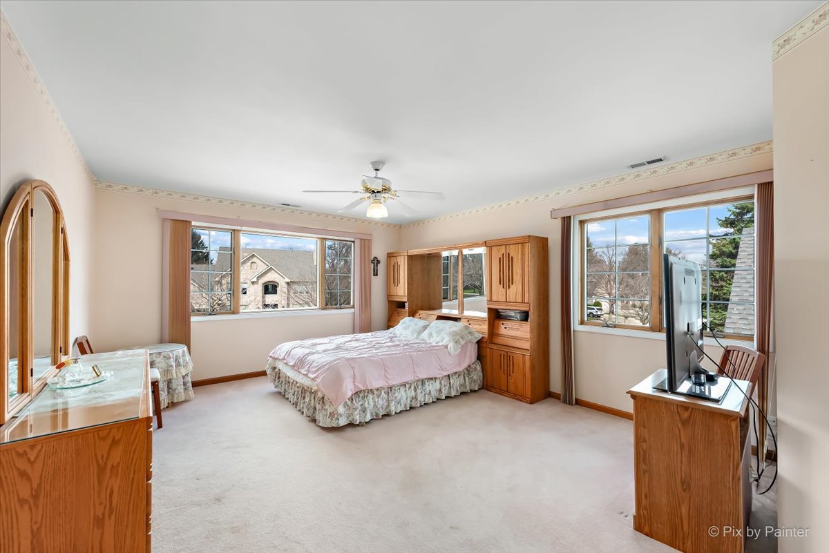 26W461 Churchill Road Winfield, IL 60190 - Photo 25 of 60 a spacious bedroom with a large bed and a large window