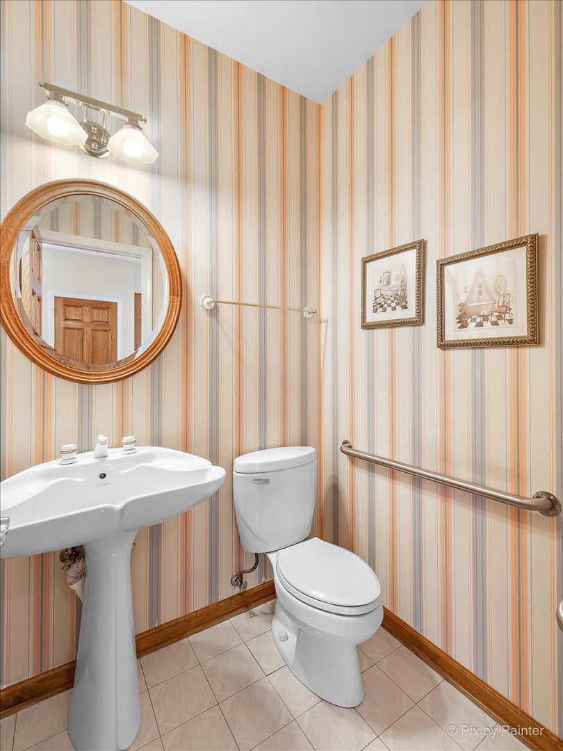 26W461 Churchill Road Winfield, IL 60190 - Photo 29 of 60 a bathroom with a toilet a sink and a mirror