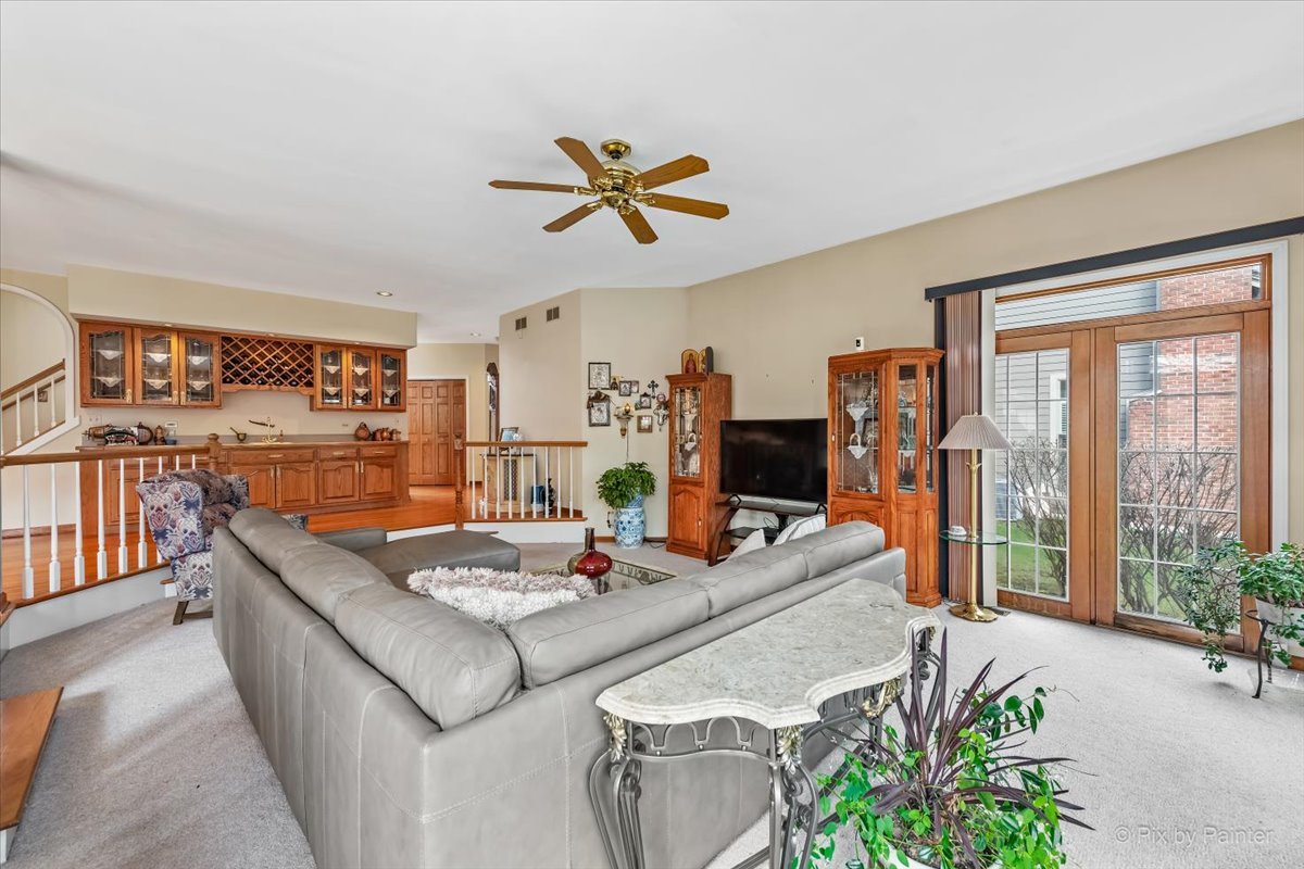 26W461 Churchill Road Winfield, IL 60190 - Photo 7 of 60 a living room with stainless steel appliances kitchen island granite countertop furniture and a potted plant
