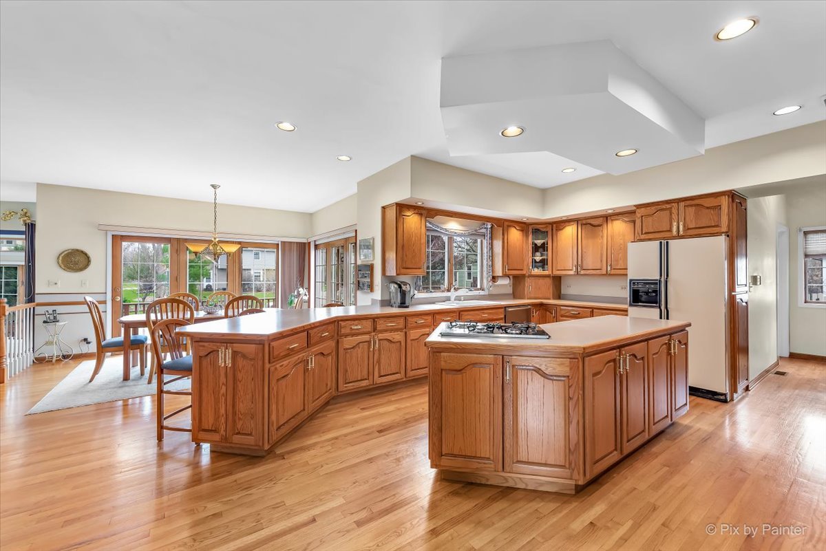 26W461 Churchill Road Winfield, IL 60190 - Photo 8 of 60 a large kitchen with stainless steel appliances granite countertop a large center island and a wooden floors