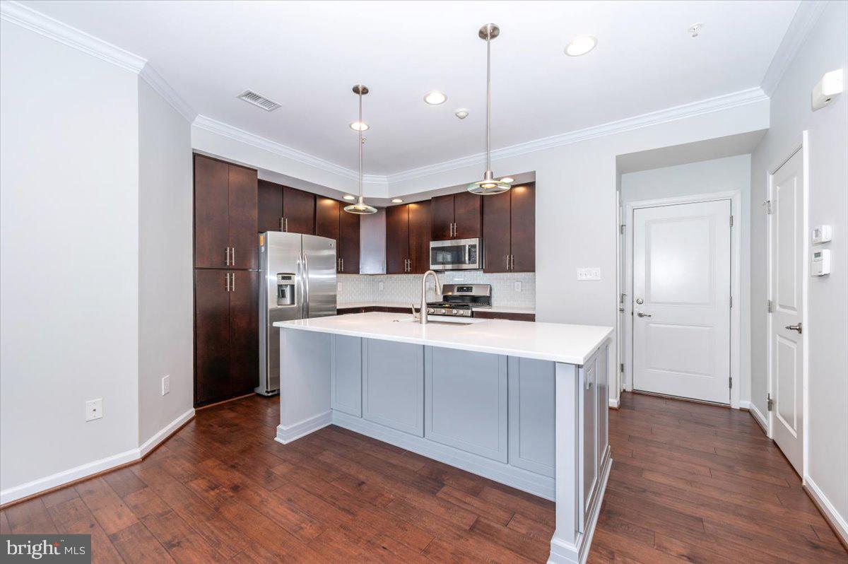 5059 Small Gains Way, Unit 5059 Frederick, MD 21703 - Photo 14 of 57 a kitchen with stainless steel appliances a refrigerator sink and microwave