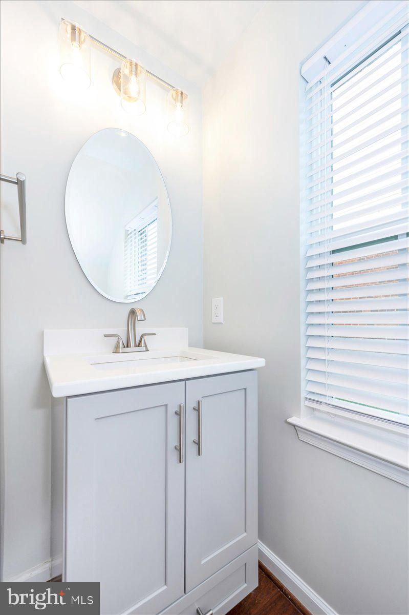 5059 Small Gains Way, Unit 5059 Frederick, MD 21703 - Photo 25 of 57 a bathroom with a sink a mirror and a window