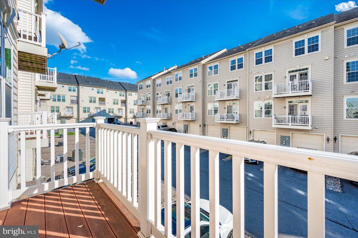 5059 Small Gains Way, Unit 5059 Frederick, MD 21703 - Photo 46 of 57 a front view of a building with glass door