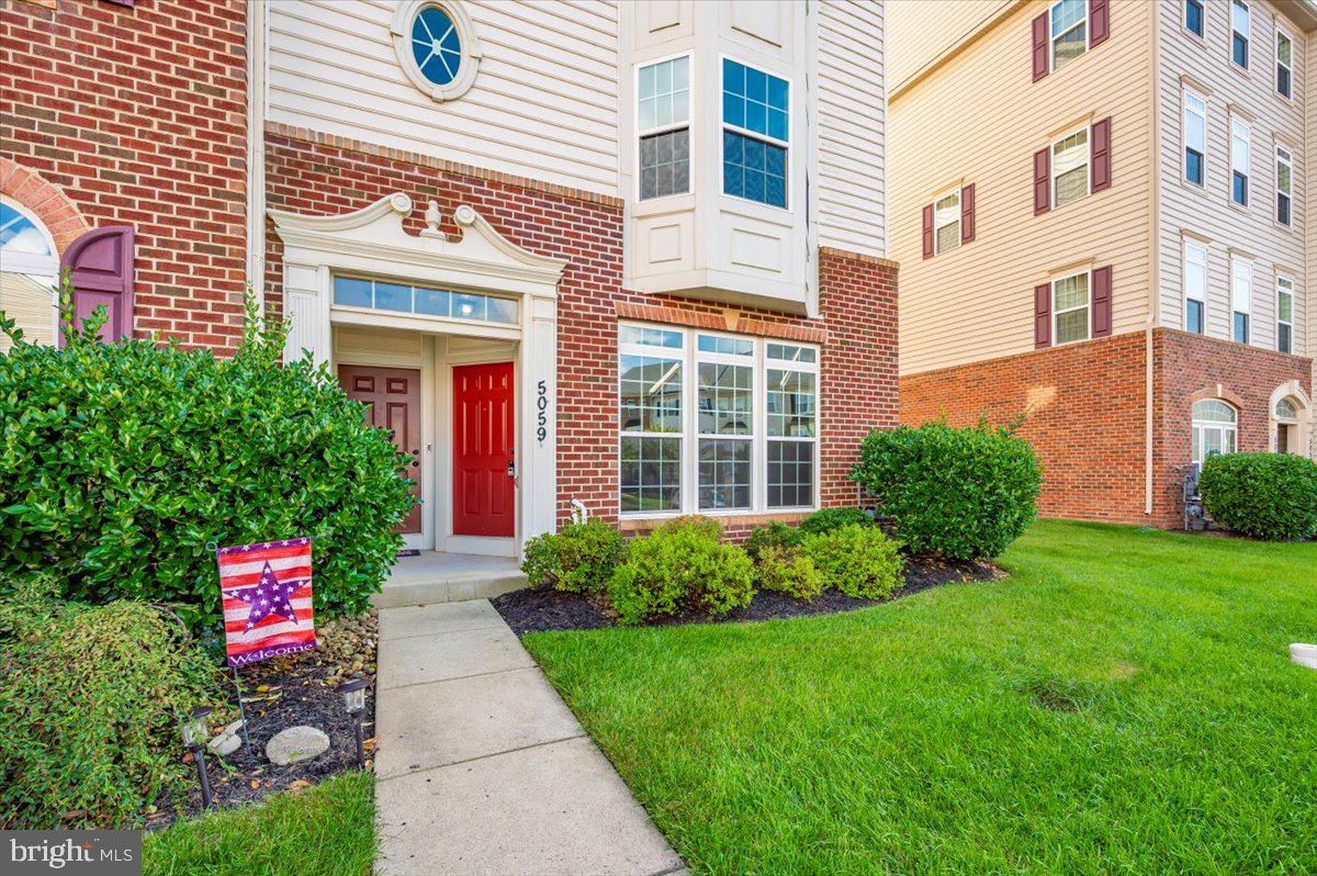 5059 Small Gains Way, Unit 5059 Frederick, MD 21703 - Photo 53 of 57 a front view of a building with garden