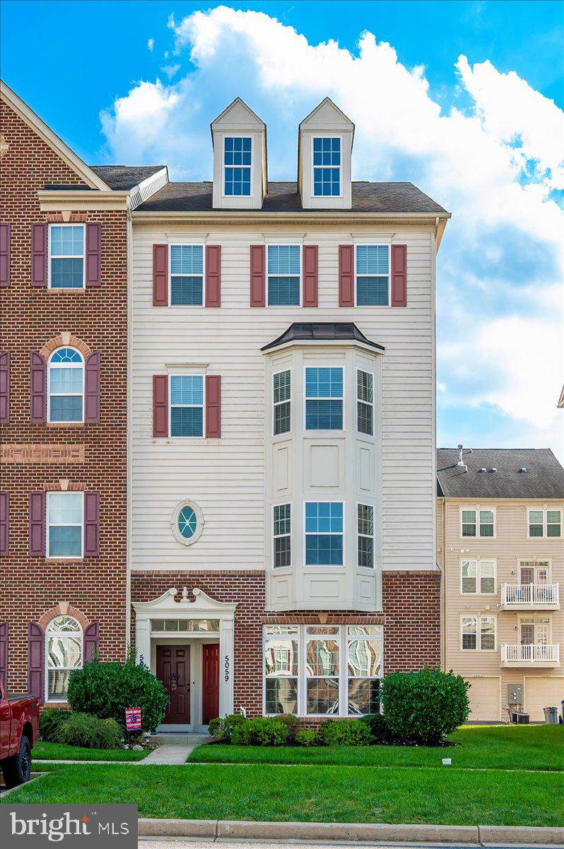 5059 Small Gains Way, Unit 5059 Frederick, MD 21703 - Photo 56 of 57 a front view of residential houses with yard and green space