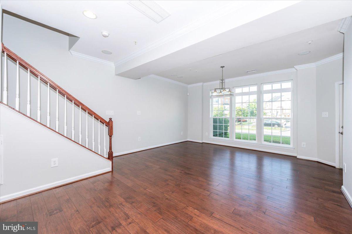 5059 Small Gains Way, Unit 5059 Frederick, MD 21703 - Photo 9 of 57 a view of an entryway with wooden floor
