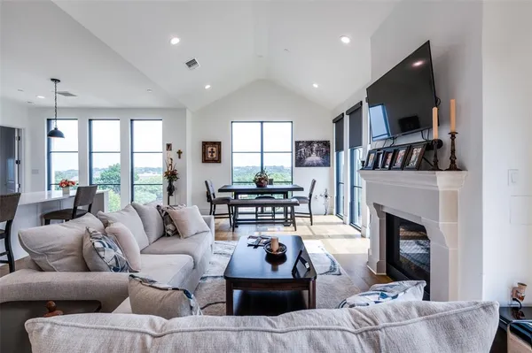 a living room with furniture fireplace and flat screen tv