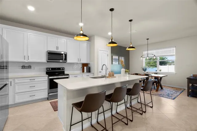 a kitchen with a table and chairs in it