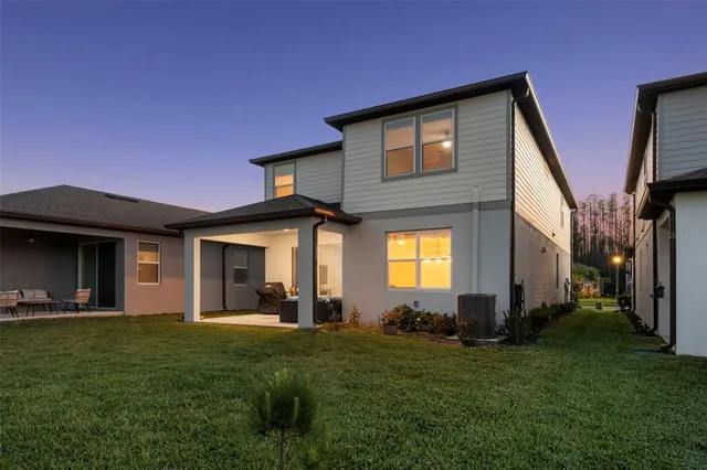a front view of house with yard and outdoor seating