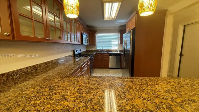 a kitchen with granite countertop sink and granite counter tops
