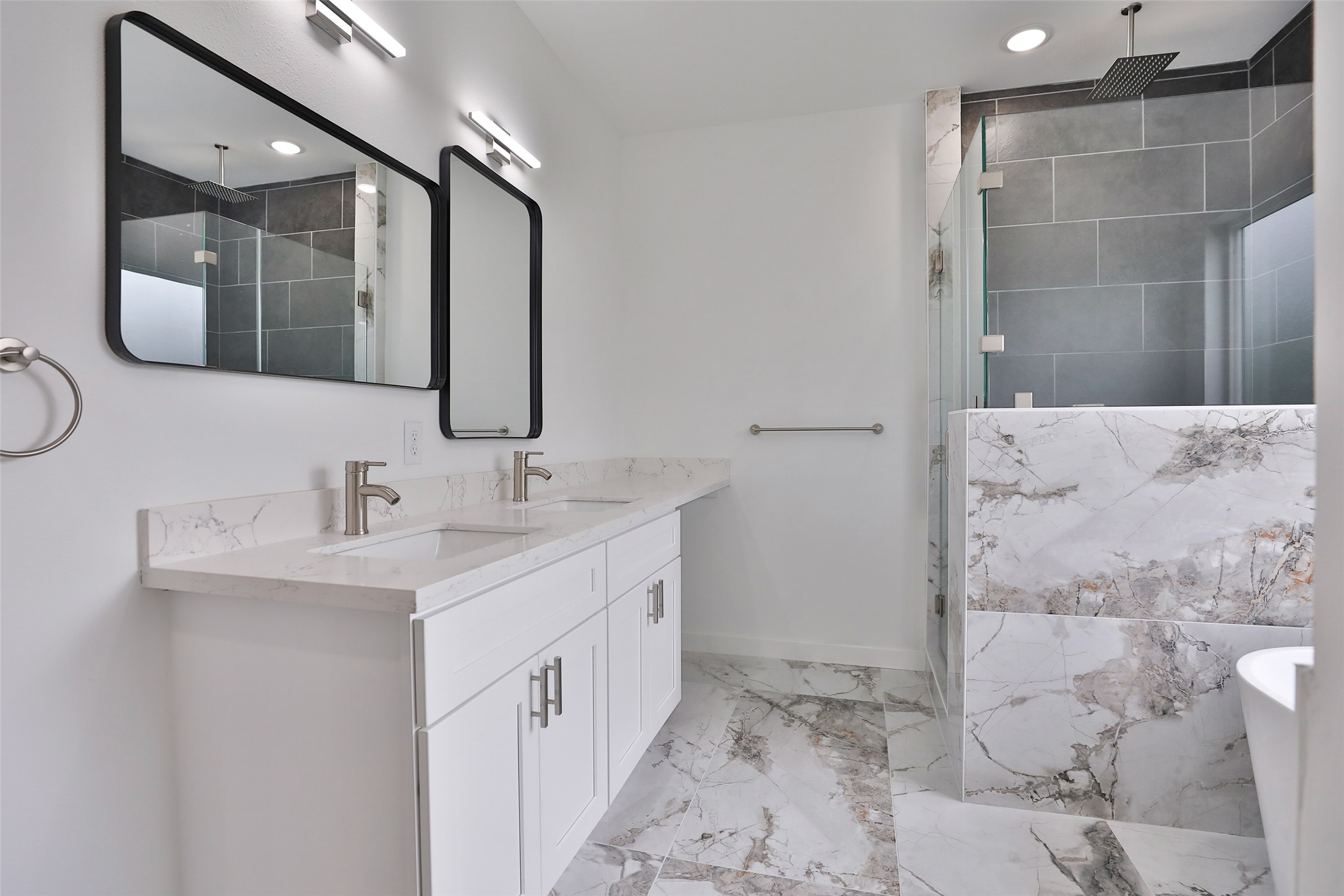 9349 Lavender Street Houston, TX 77016 - Photo 16 of 29 a bathroom with a double vanity sink mirror and shower