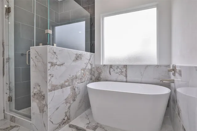 a bathroom with a double vanity sink mirror and shower