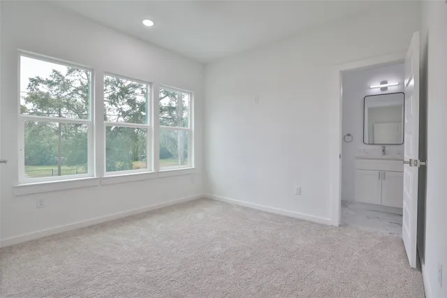 an empty room with windows and closet