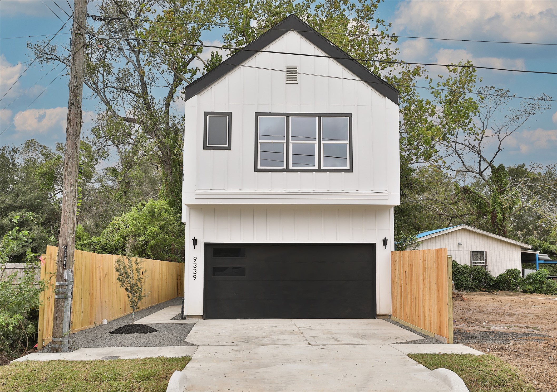9349 Lavender Street Houston, TX 77016 - Photo 27 of 29 a view of a house with a yard and garage