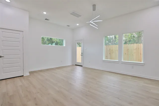 a view of kitchen with wooden floor and electronic appliances