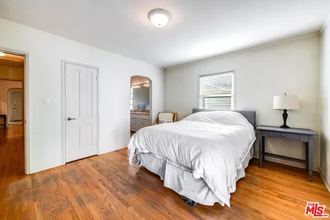 a spacious bedroom with a bed and a window