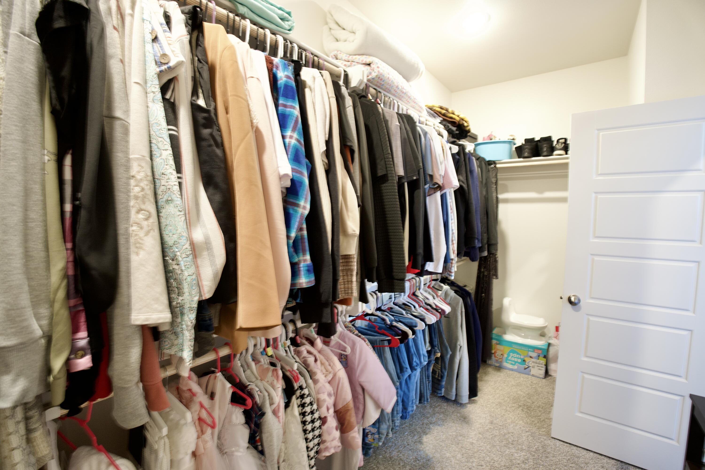 5801 Winfield Avenue Lubbock, TX 79407 - Photo 11 of 20 a view of walk in closet with clothes and shoes