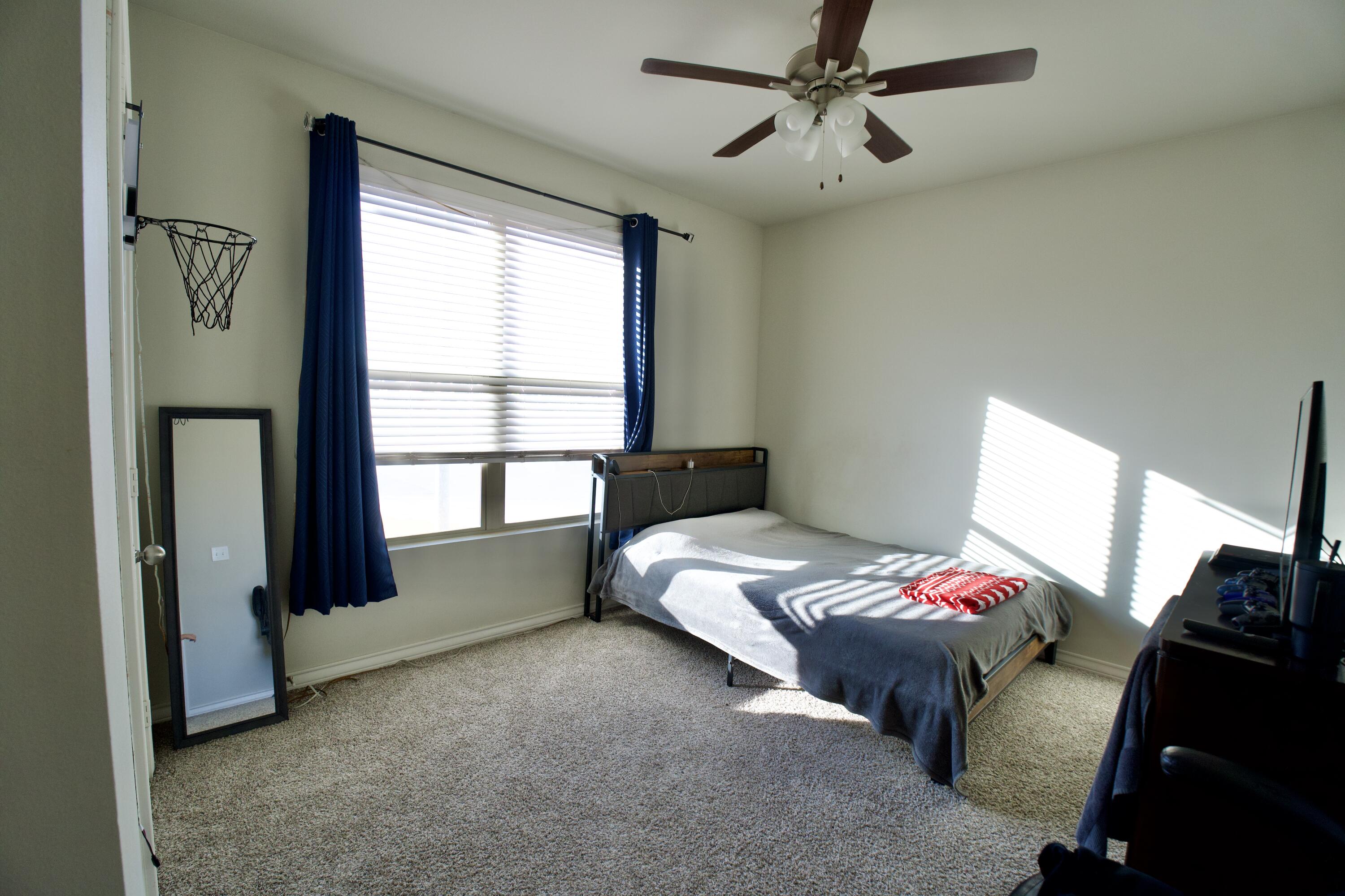 5801 Winfield Avenue Lubbock, TX 79407 - Photo 14 of 20 a bedroom with bed and a window