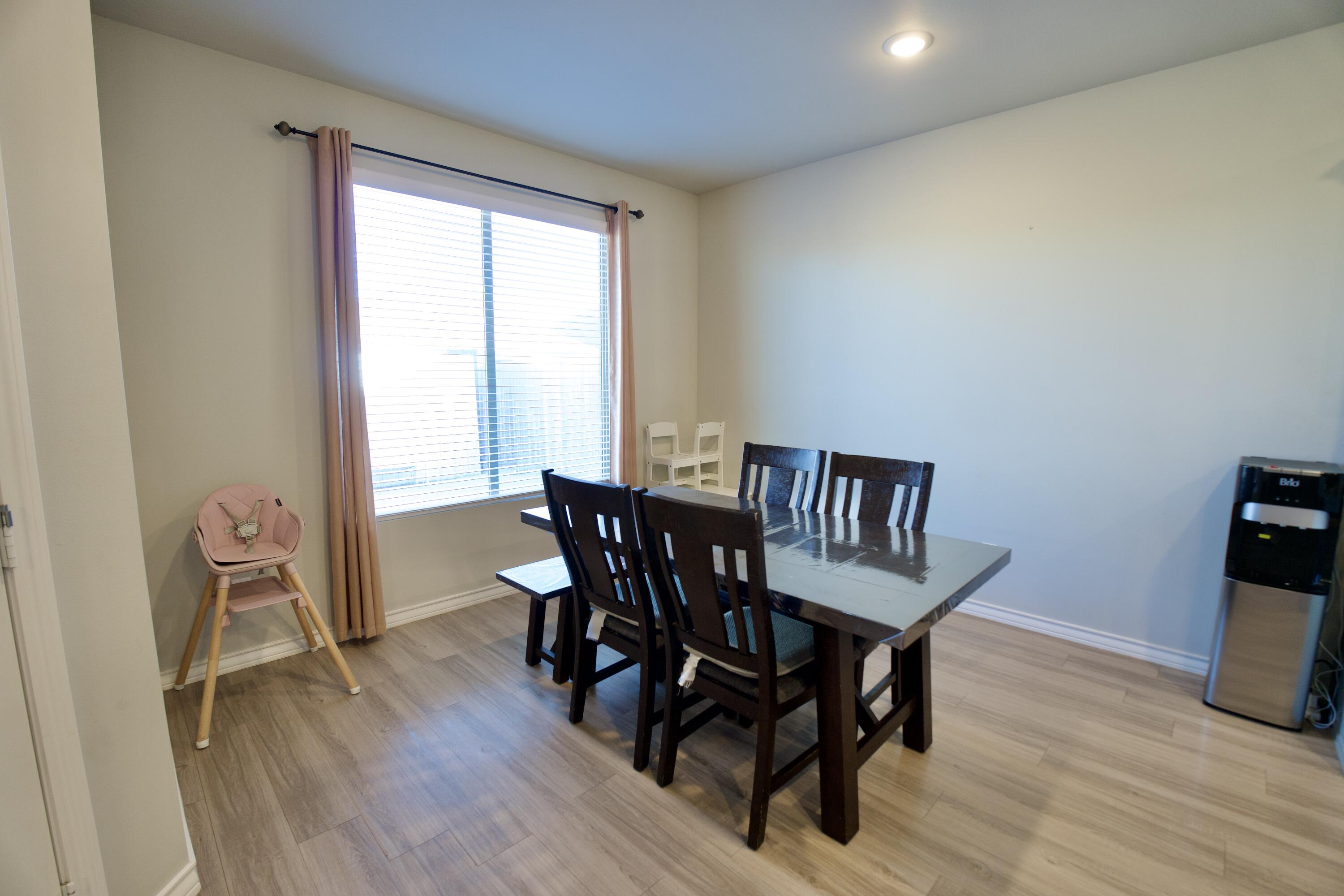 5801 Winfield Avenue Lubbock, TX 79407 - Photo 7 of 20 a view of a dining room with furniture and wooden floor