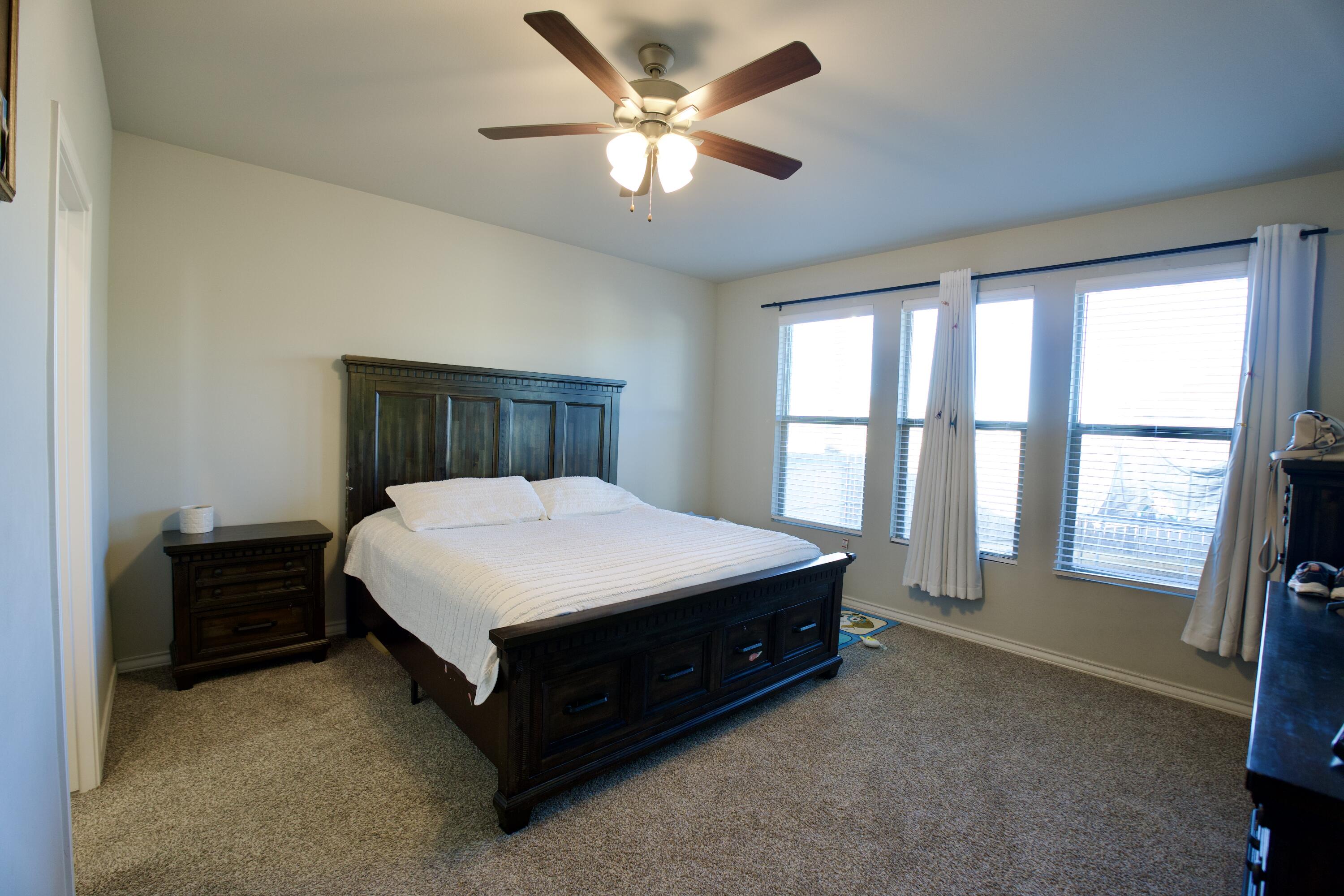5801 Winfield Avenue Lubbock, TX 79407 - Photo 8 of 20 a spacious bedroom with a bed and a large window