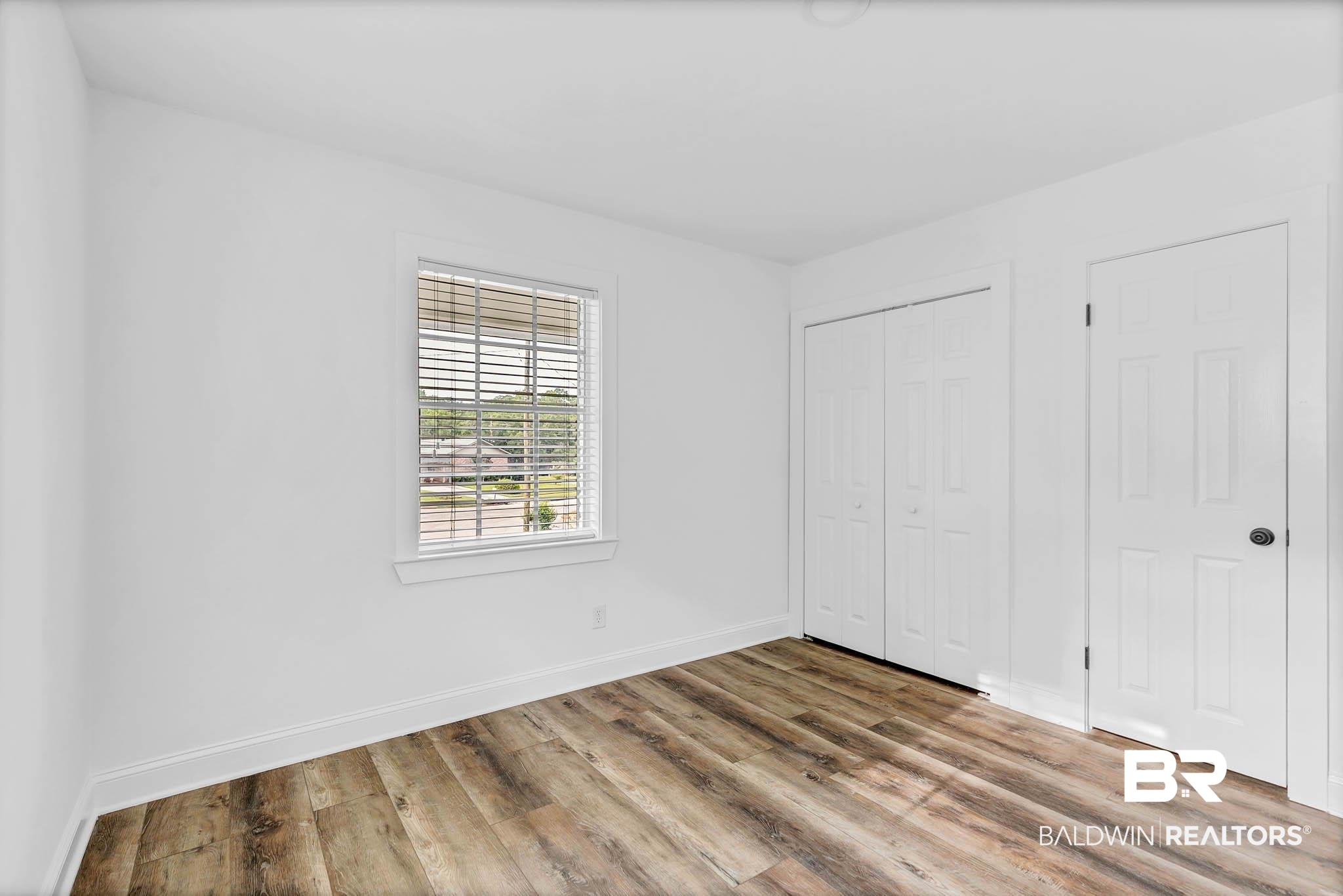 4705 Sherry Court Mobile, AL 36693 - Photo 49 of 100 Unfurnished bedroom featuring wood finished floors and a closet