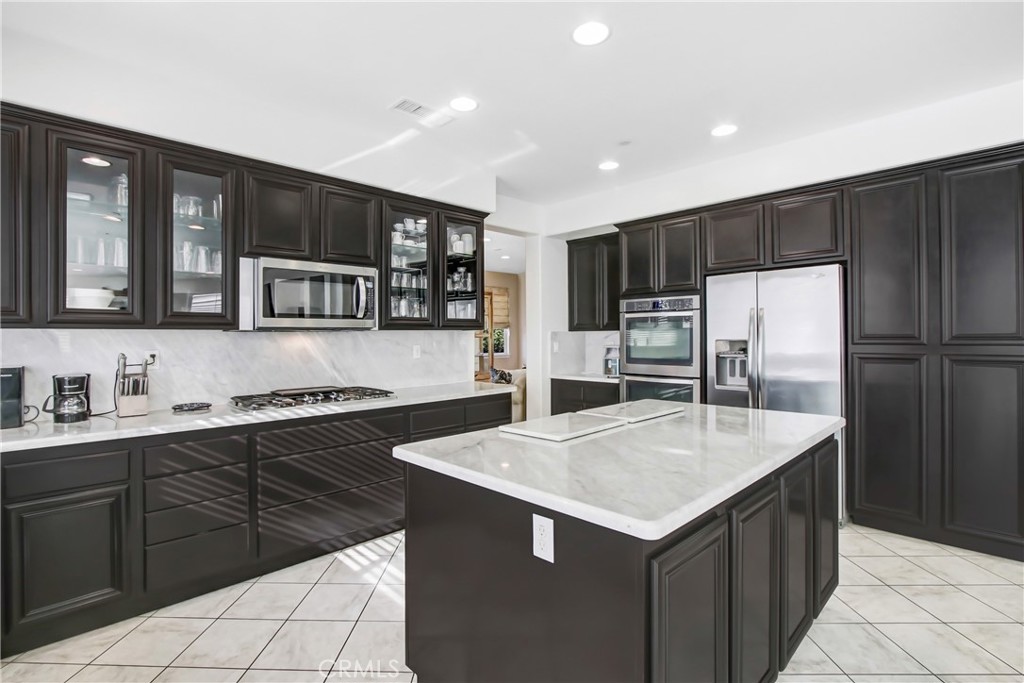 18125 Friendly Lane Riverside, CA 92508 - Photo 3 of 5 a kitchen with a stove a refrigerator and a sink