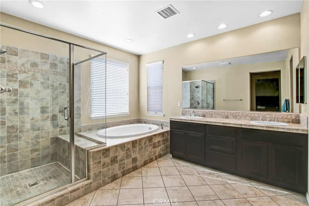 18125 Friendly Lane Riverside, CA 92508 - Photo 4 of 5 a spacious bathroom with a granite countertop sink mirror and shower