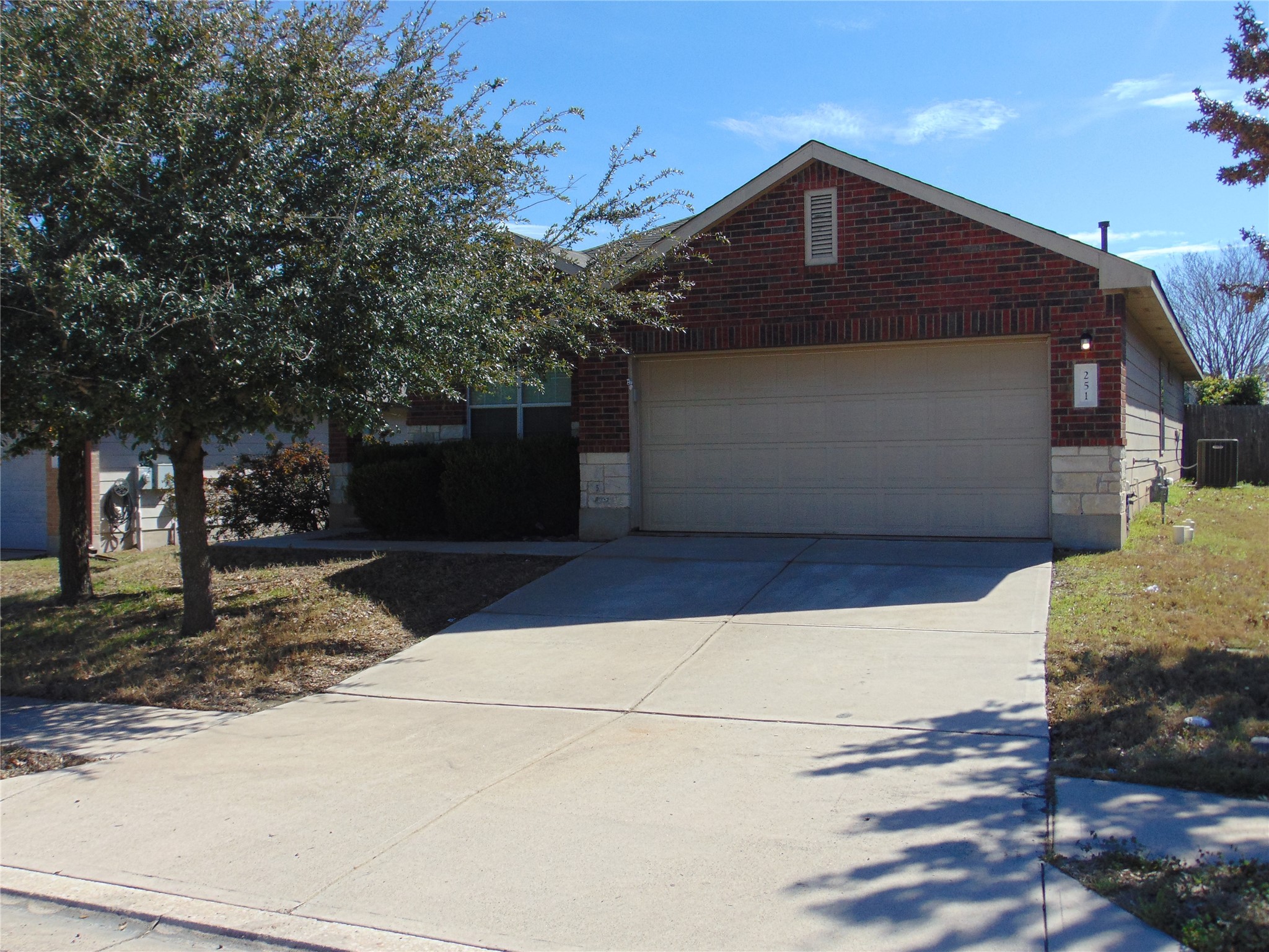 251 Wolfberry Path Buda, TX 78610 - Photo 1 of 17 a front view of a house with a yard