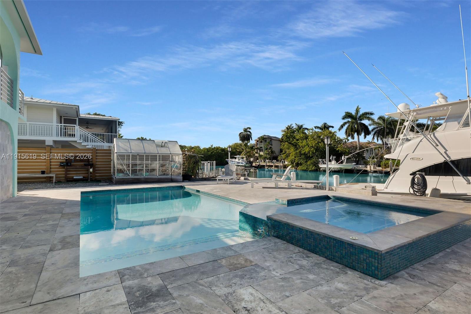 232 West Seaview Drive Marathon, FL 33050 - Photo 32 of 72 a view of a swimming pool with a lounge chair