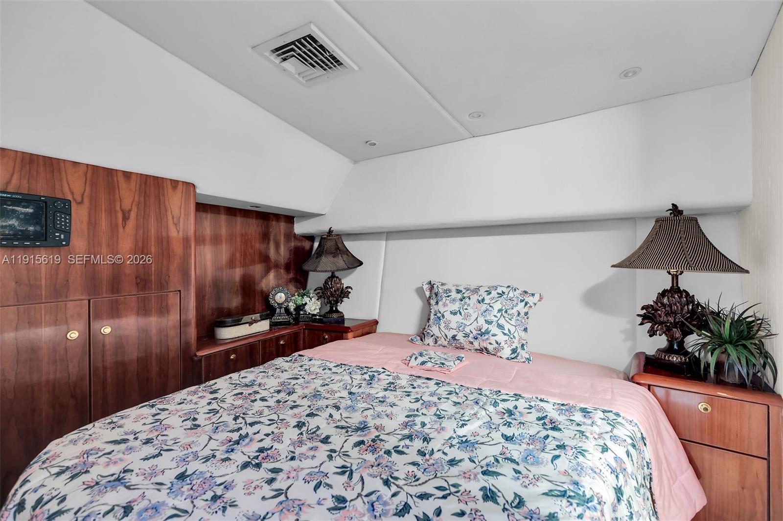 232 West Seaview Drive Marathon, FL 33050 - Photo 61 of 72 a bedroom with a bed and a potted plant