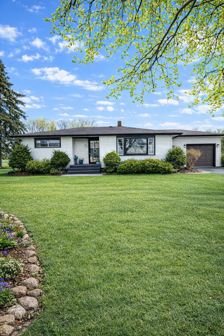 12310 Price Road Hebron, IL 60034 - Photo 1 of 20 a house view with a garden space