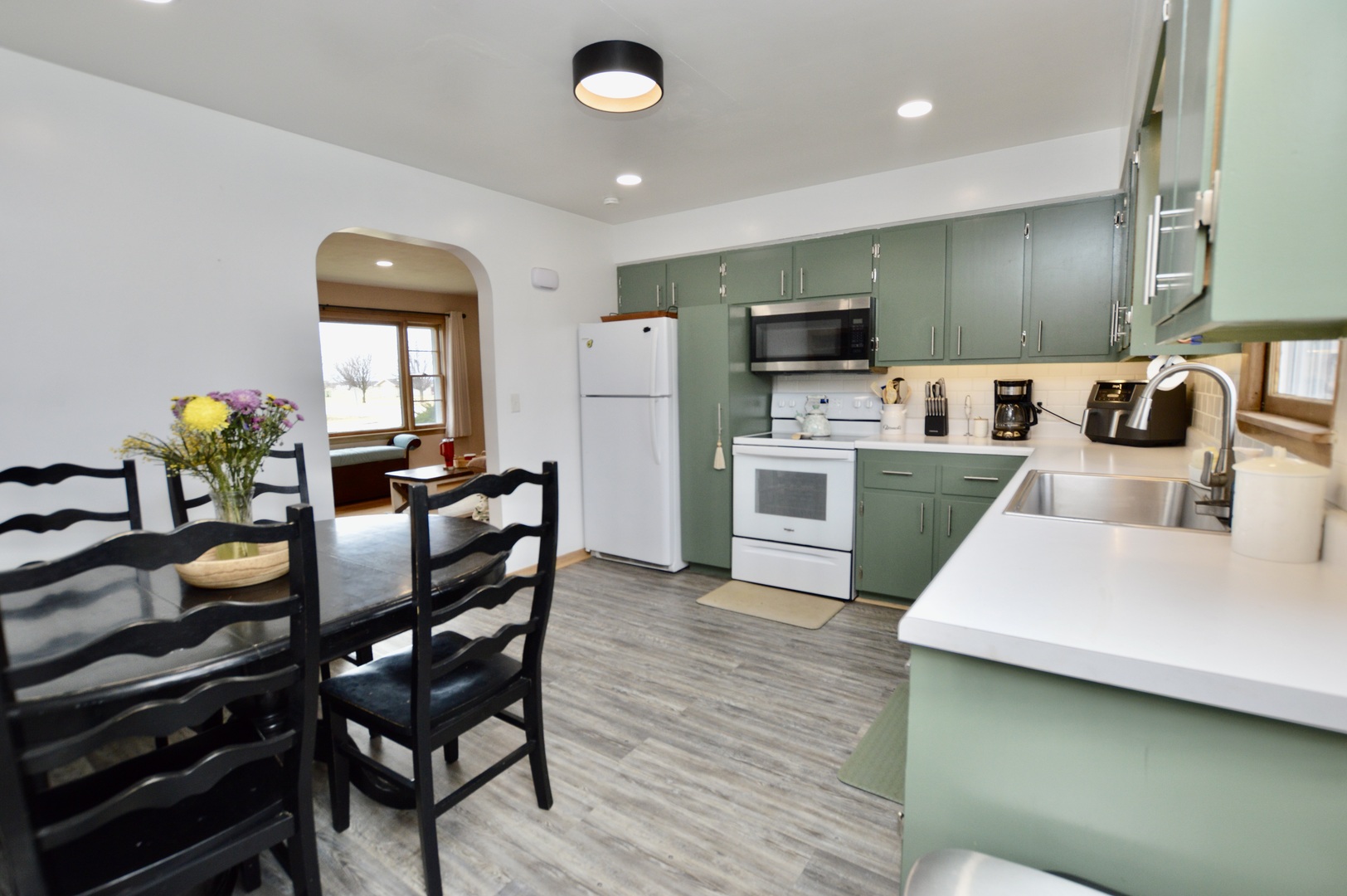 12310 Price Road Hebron, IL 60034 - Photo 4 of 20 a kitchen with stainless steel appliances granite countertop a table chairs and a refrigerator