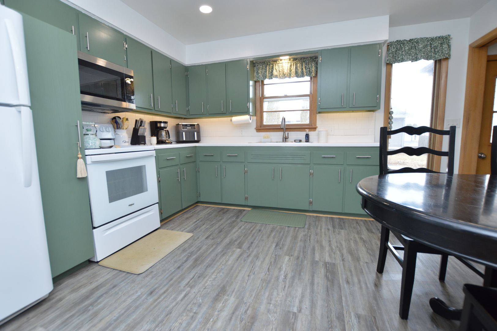 12310 Price Road Hebron, IL 60034 - Photo 5 of 20 a kitchen with a wooden floor a sink and a window