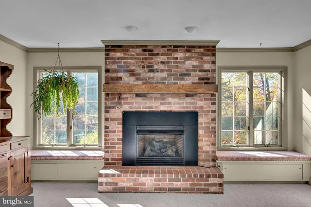 a living room with a fireplace and a large window