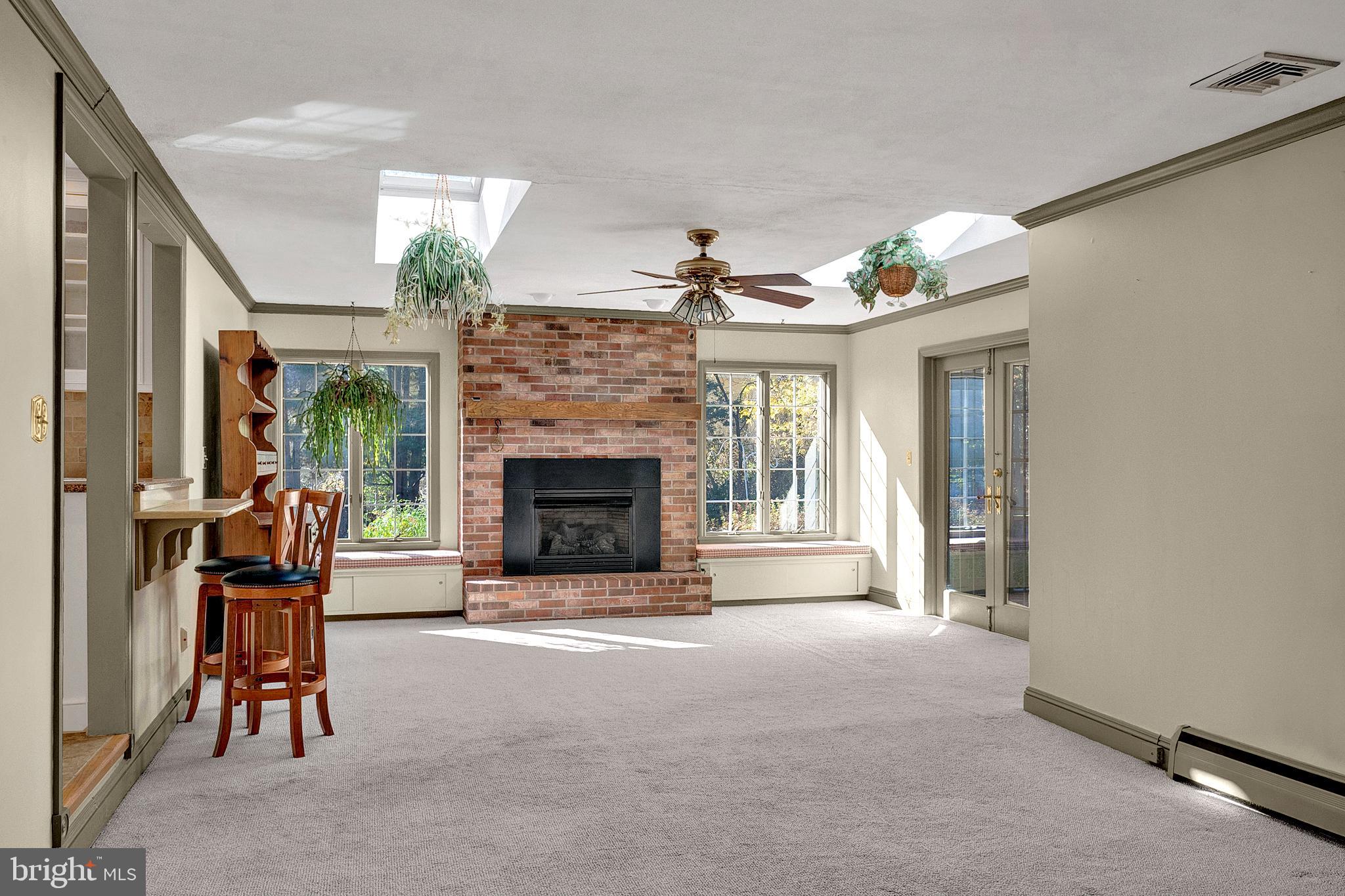 4 Old Forge Lane Ewing, NJ 08618 - Photo 18 of 35 a living room with furniture a fireplace and a floor to ceiling window