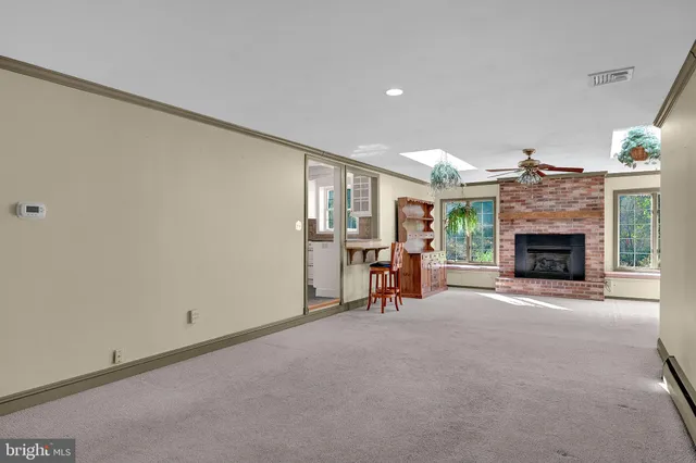 a view of a livingroom with a fireplace and chandelier