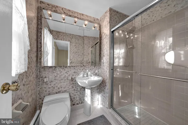 a bathroom with a toilet sink and shower