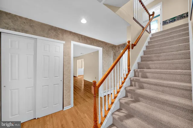 a view of staircase with white walls and a window