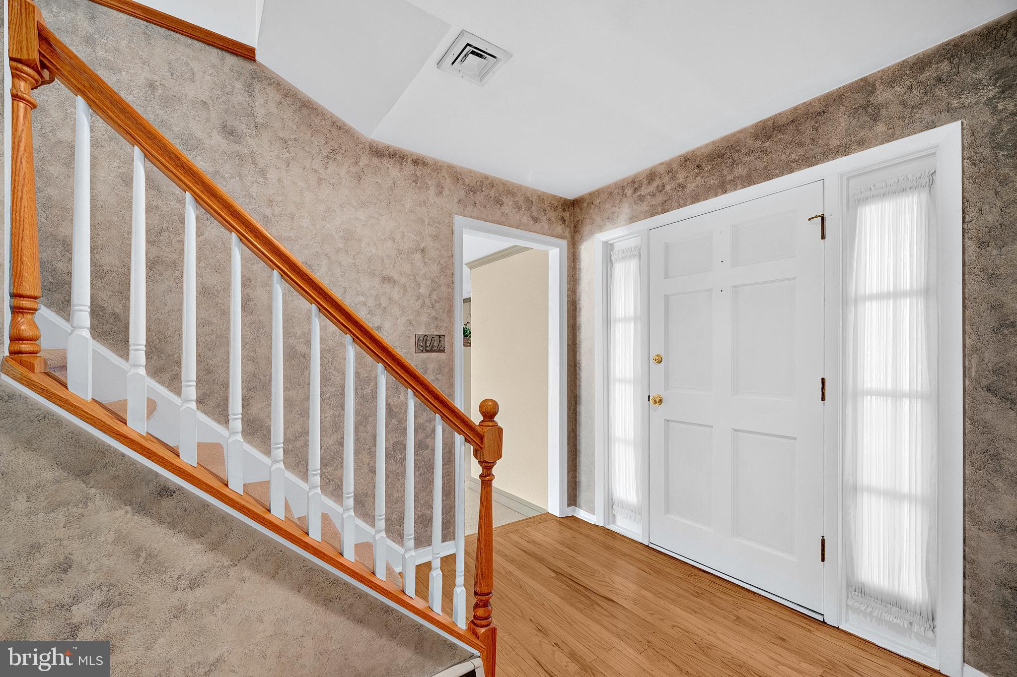 4 Old Forge Lane Ewing, NJ 08618 - Photo 5 of 35 a view of a hallway with wooden floor and staircase